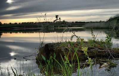 Scenic view of lake against cloudy sky