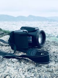 Close-up of camera on beach