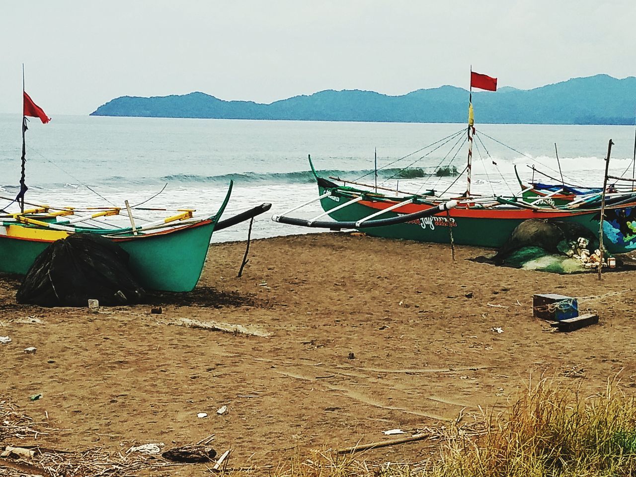 VIEW OF BOATS MOORED AT BEACH