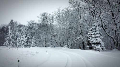 Road passing through snow covered landscape