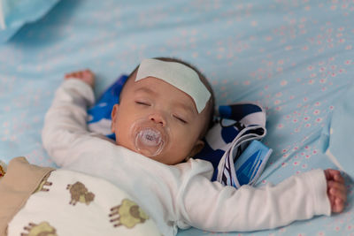 Cute baby lying on bed