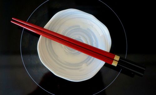 Directly above shot of chopsticks on top of bowl