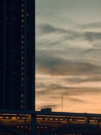 Low angle view of skyscrapers against sky during sunset