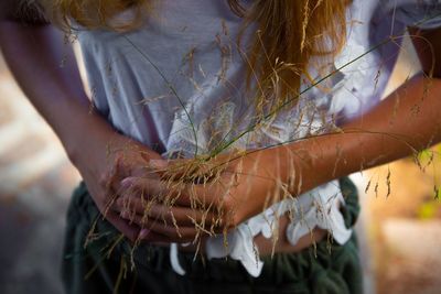 Close-up of woman holding plant