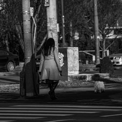 Woman with dog standing by plants