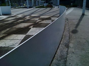 Shadow of railing on footpath