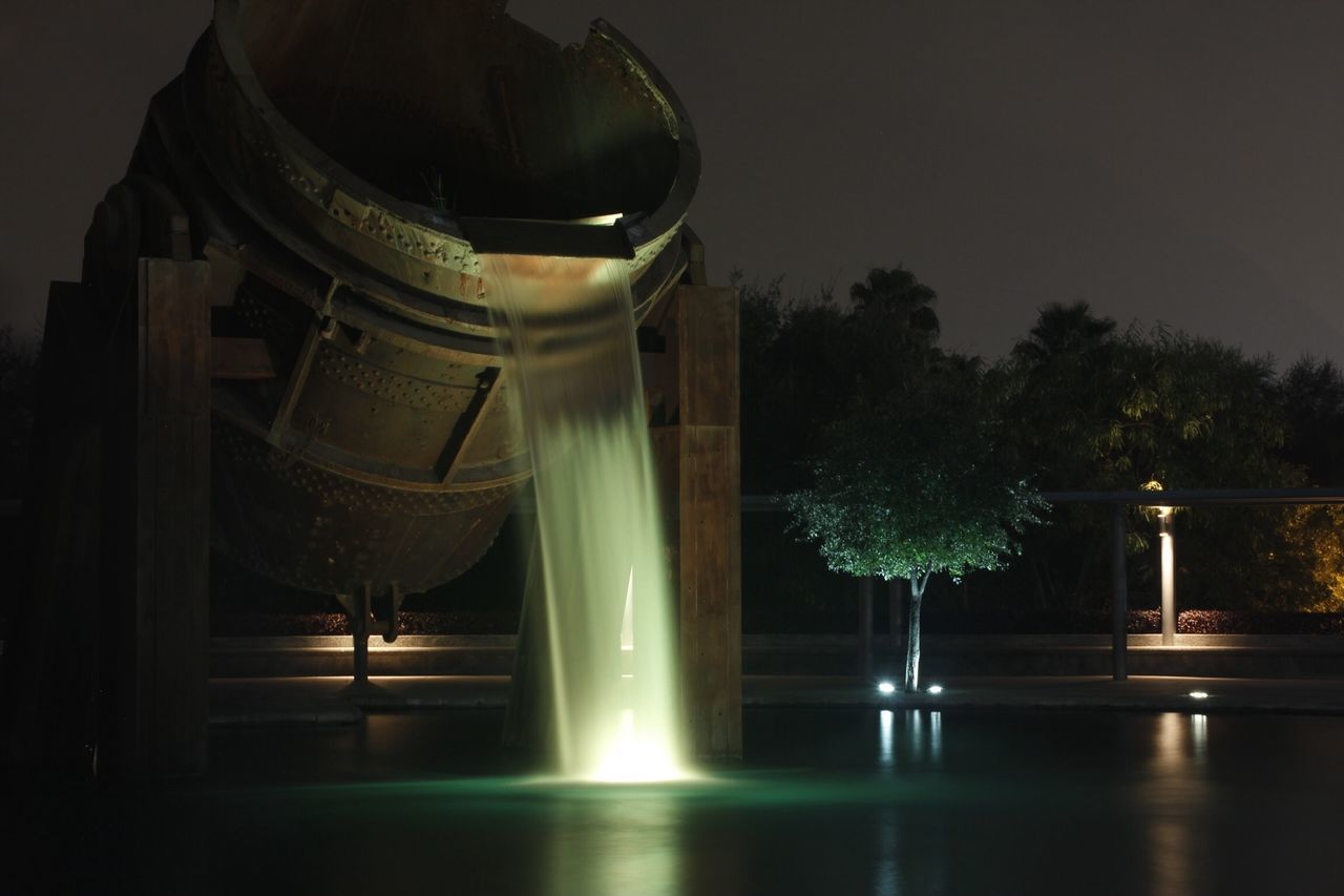 built structure, architecture, fountain, illuminated, night, low angle view, building exterior, tree, clear sky, famous place, architectural column, travel destinations, sculpture, art and craft, history, no people, sky, art, statue, column