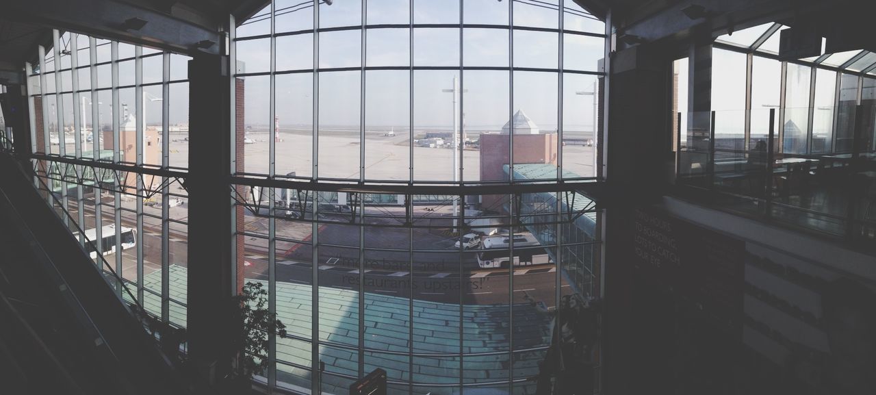 indoors, window, glass - material, transparent, architecture, built structure, interior, glass, modern, ceiling, skylight, reflection, day, looking through window, building, no people, home interior, city, transportation, vehicle interior