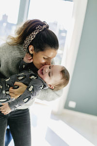 Rear view of mother with baby at home