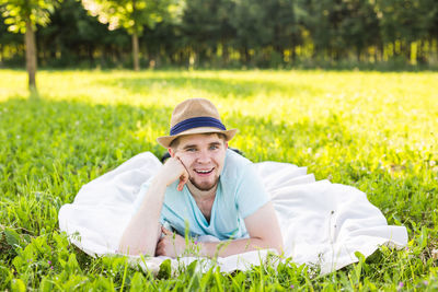 Portrait of smiling man lying in grass