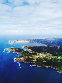 Aerial view of sea and cityscape against sky