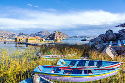 Boats and thatched huts on floating island