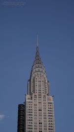 Low angle view of modern building against blue sky