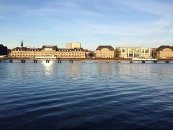 View of city by sea against sky