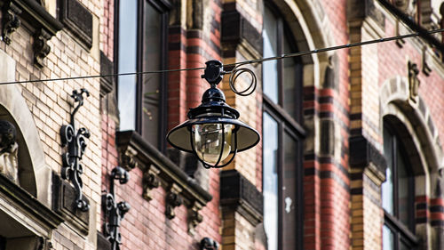 Low angle view of lighting equipment against building