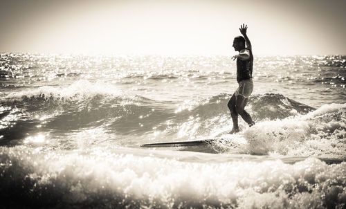Woman standing by sea