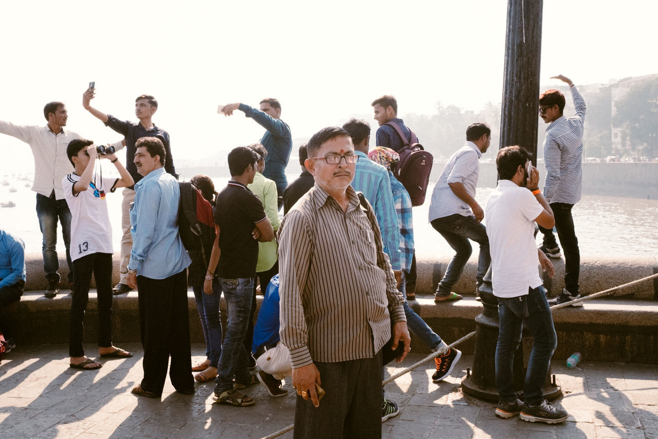 group of people, real people, large group of people, men, women, crowd, standing, casual clothing, day, full length, nature, adult, leisure activity, lifestyles, males, togetherness, sunlight, group, outdoors, human arm, arms raised