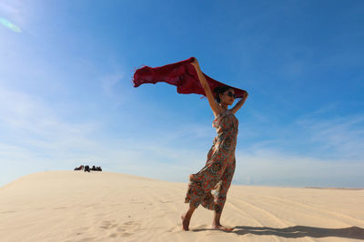 A female model posing on the sand dune desert