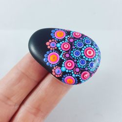 Close-up of hand holding multi colored pencils over white background