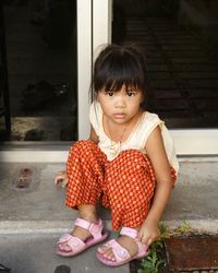 Portrait of girl sitting outdoors