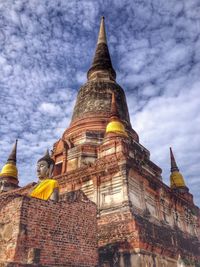 Low angle view of temple against cloudy sky