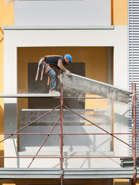 Low angle view of man working at construction building