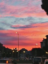 High section of buildings against cloudy sky at sunset