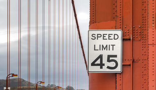 Close-up of speed limit sign on bridge