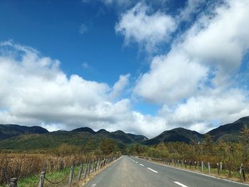 Empty road along countryside landscape