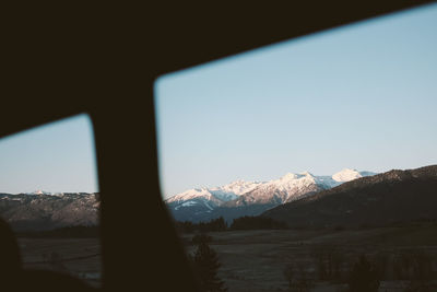 Scenic view of snowcapped mountains against clear sky