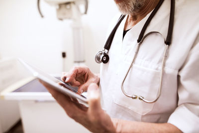 Close-up of vet using tablet in clinic