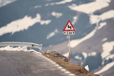 Road sign against mountain