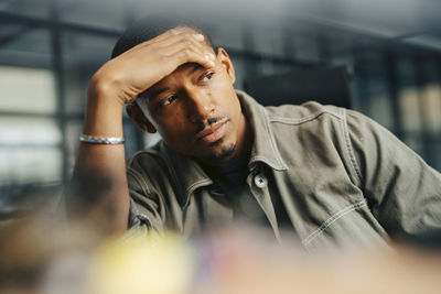 Worried businessman with head in hand at office