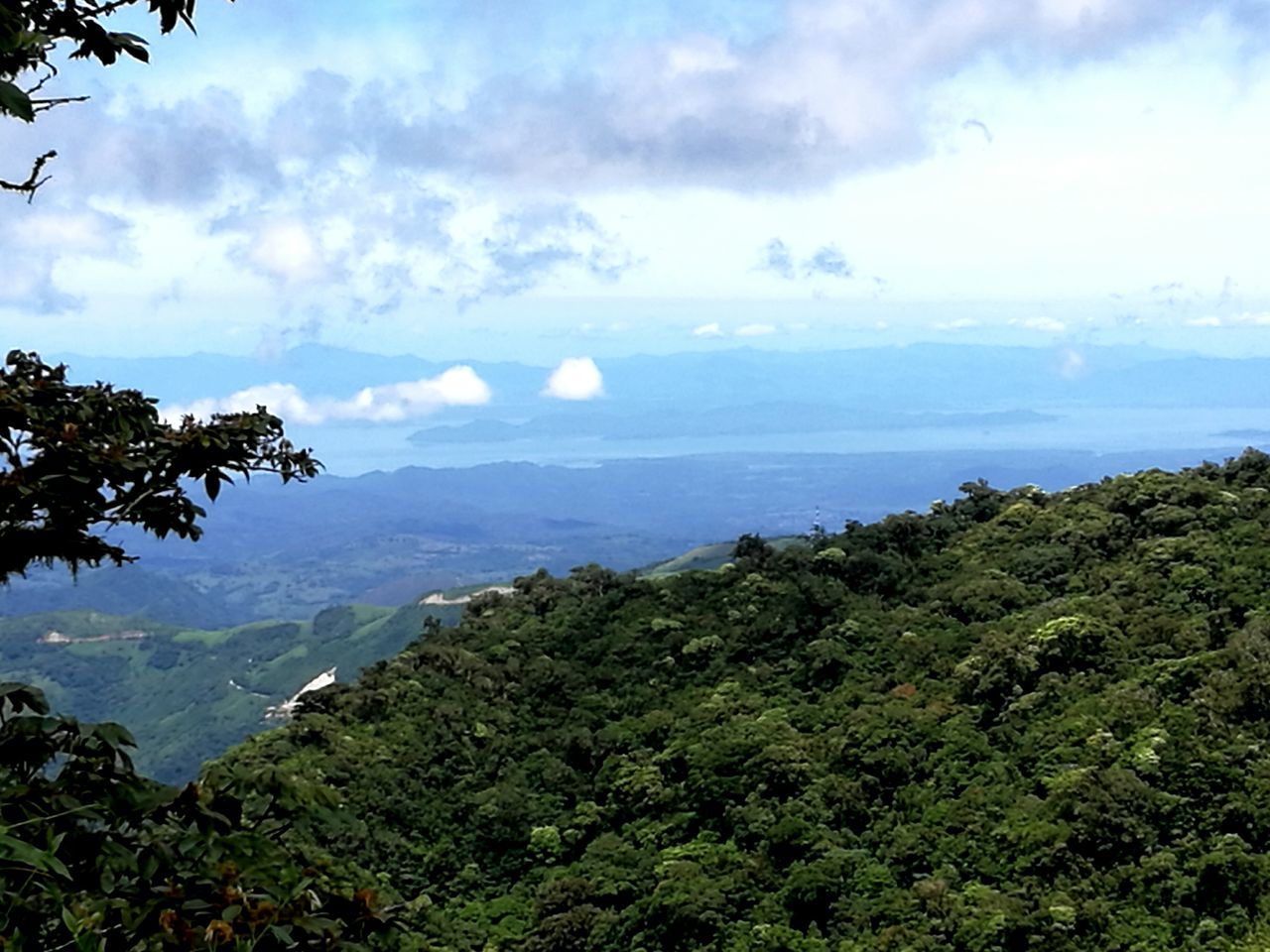 beauty in nature, mountain, nature, sky, cloud - sky, scenics, day, tranquility, tranquil scene, landscape, outdoors, no people, green color, scenery, mountain range, tree