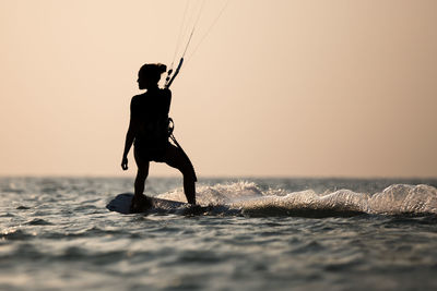 Kitesurfing, kiteboarding in exotic location, tropical island. kitesurfer activities.