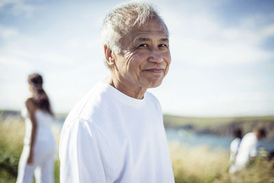 Portrait of senior man standing in field