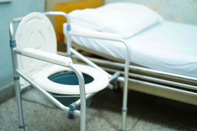 Empty seat bowl and bed in hospital