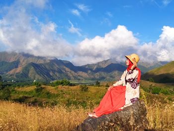 Person on field against mountain range