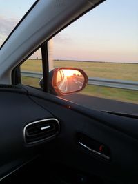 View of car windshield at sunset