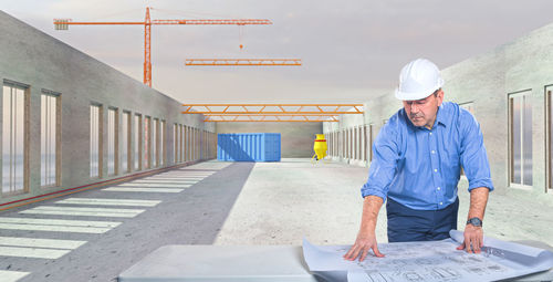 Rear view of man working at construction site