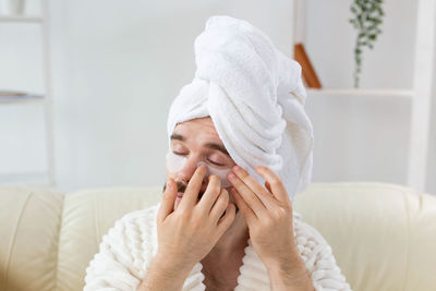 Man applying eye mask