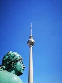 Low angle view of statue against blue sky