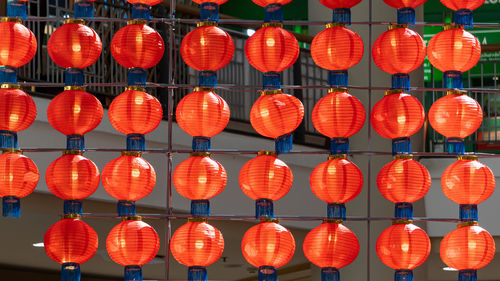 Low angle view of illuminated lanterns hanging at night