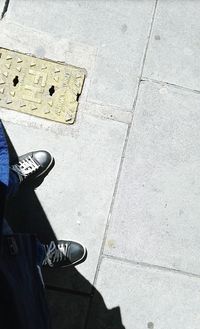 Low section of man standing on street