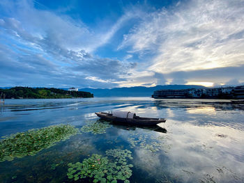 Boat moored in sea against sky