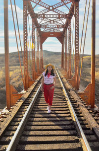 Portrait of man standing on railroad track