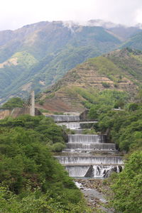 High angle view of dam and mountains against sky