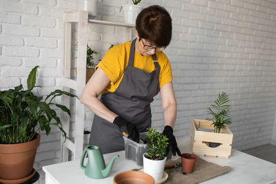 Side view of man gardening at home