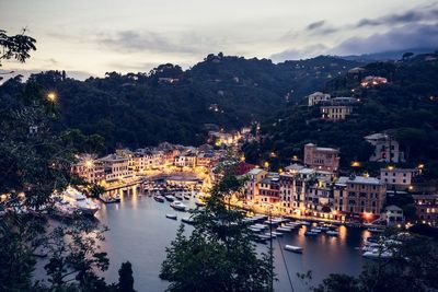 High angle view of townscape by river against sky during sunset