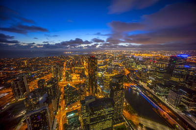 Aerial view of city lit up at night